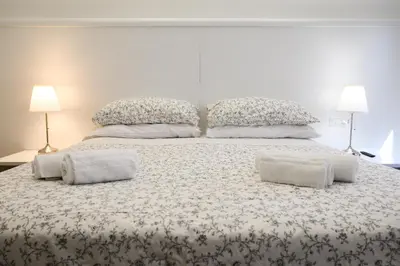 a large bed with two pillows on top of it at Domus Pio VIII in Rome