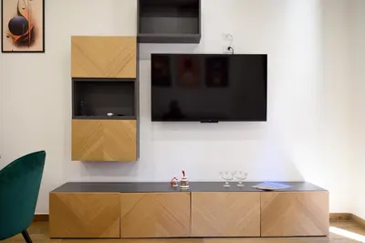a living room with a tv and a wooden cabinet at Domus Pio VIII in Rome
