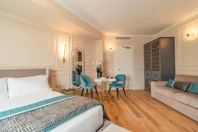 a bedroom with a bed and a couch and a table at Trevi Imperial Suite 2 in Rome