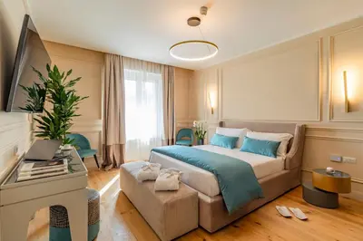 a bedroom with a large bed and a couch at Trevi Imperial Suite 2 in Rome