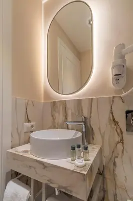 a bathroom with a sink and a mirror at Trevi Imperial Suite 2 in Rome