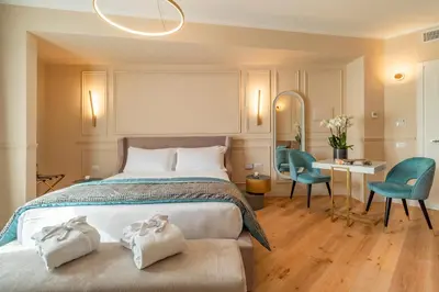 a bedroom with a bed and a desk and chairs at Trevi Imperial Suite 2 in Rome