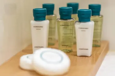 a group of bottles of lotion on a wooden table at Trevi Imperial Suite 1 in Rome