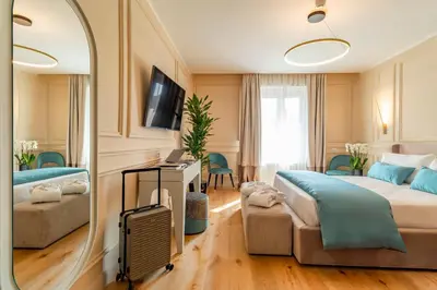 a bedroom with a large bed and a mirror at Trevi Imperial Suite 1 in Rome