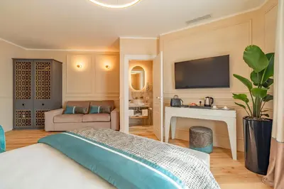 a bedroom with a bed and a tv on the wall at Trevi Imperial Suite 1 in Rome