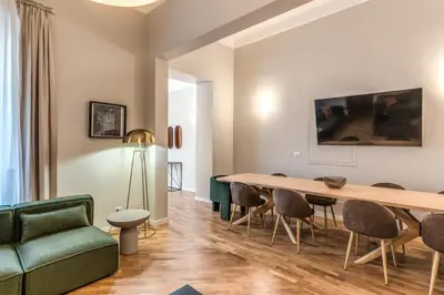 a living room with a table and chairs and a couch at DOWNTOWN SRL - The Great Court and The Great Chill in Rome