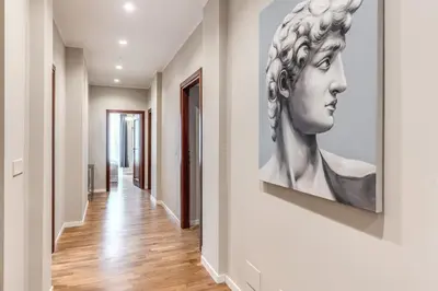 a painting of a bust on a wall in a hallway at DOWNTOWN SRL - The Great Court and The Great Chill in Rome