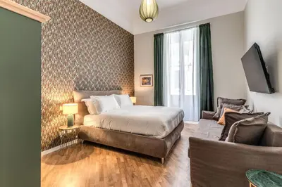 a bedroom with a bed and a couch at DOWNTOWN SRL - The Great Court and The Great Chill in Rome