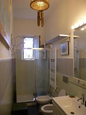 a bathroom with a toilet and a sink and a shower at Esquilino Piano Alto in Rome