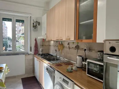 a kitchen with a sink and a stove top oven at Feel at home in Rome