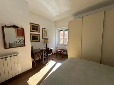 a bedroom with a bed and a desk and a window at Feel at home in Rome