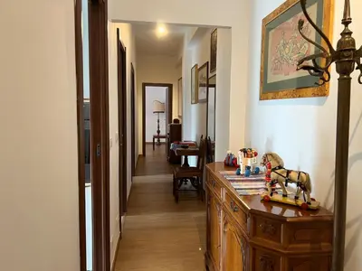 a hallway with a wooden dresser in a room at Feel at home in Rome
