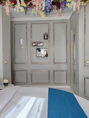 a bedroom with a bed with flowers on the wall at Flowers' Circle of piazza di Spagna in Rome