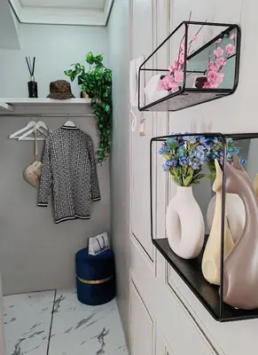 a room with a shelf with flowers and a vase at Flowers' Circle of piazza di Spagna in Rome