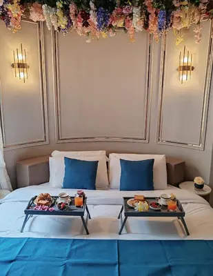 a bed with two serving trays of food on it at Flowers' Circle of piazza di Spagna in Rome