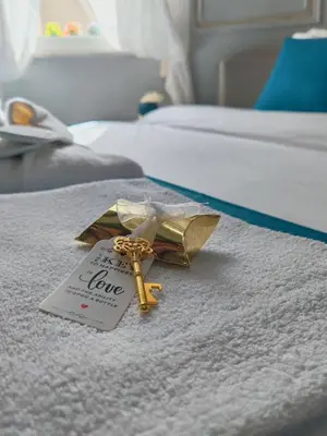 a key on a bed with a love tag on it at Flowers' Circle of piazza di Spagna in Rome