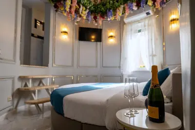 a bedroom with a bed and a bottle of champagne at Flowers' Circle of piazza di Spagna in Rome