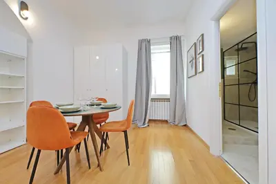 a dining room with a table and orange chairs at Modern flat in Termini Station in Rome
