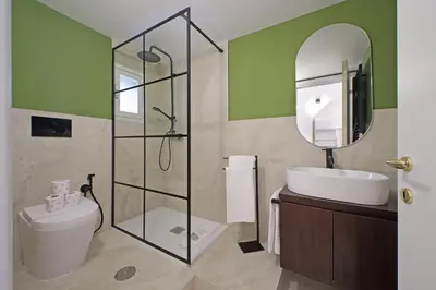 a bathroom with a toilet and a sink and a mirror at Modern flat in Termini Station in Rome