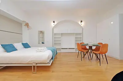 a bedroom with a bed and a table and chairs at Modern flat in Termini Station in Rome