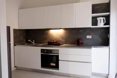 a kitchen with white cabinets and a stove at A un passo da San Pietro in Rome