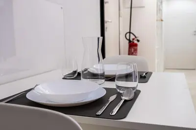 a table with plates and glasses on a black tray at A un passo da San Pietro in Rome