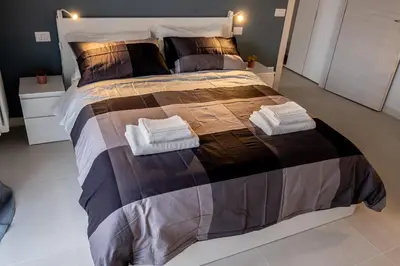 a bedroom with a large bed with two towels on it at A un passo da San Pietro in Rome
