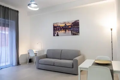 a living room with a couch and a table at A un passo da San Pietro in Rome