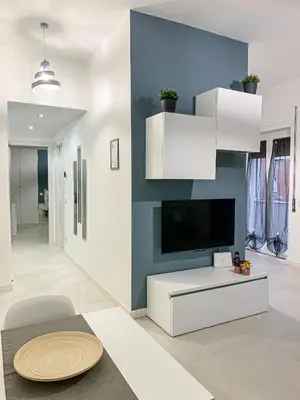 a living room with a tv and a white couch at A un passo da San Pietro in Rome