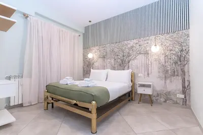 a bedroom with a bed with a painting on the wall at Casa Arco Roma in Rome