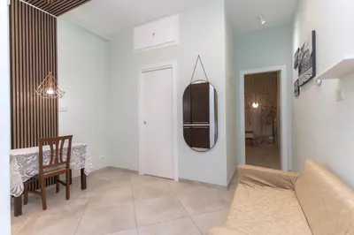a living room with a couch and a table and a mirror at Casa Arco Roma in Rome