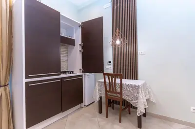 a kitchen with a table and a table and a chair at Casa Arco Roma in Rome