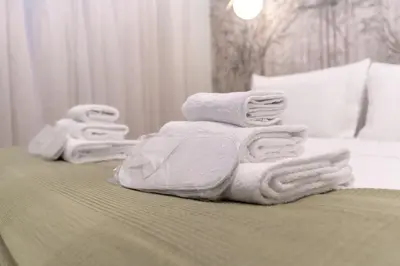 a pile of towels sitting on top of a bed at Casa Arco Roma in Rome