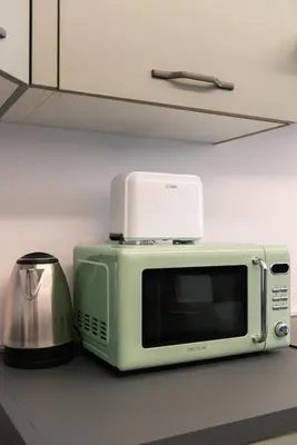 a microwave sitting on a counter next to a toaster at Casa Vacanze Ourplaces Sacchetti in Rome
