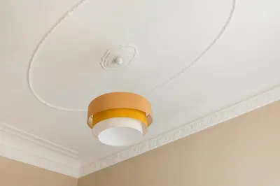 a ceiling with a light on a white ceiling at Casa Augusta, a Burghesius home in Rome