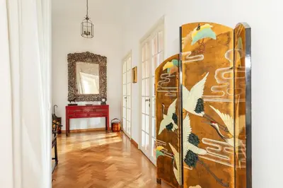 a living room with a large wooden door in a room at Casa Augusta, a Burghesius home in Rome