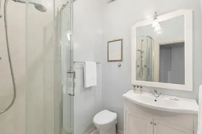 a bathroom with a shower and a toilet and a sink at Casa Augusta, a Burghesius home in Rome