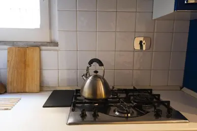 a tea kettle on a stove top in a kitchen at Cozy 2BR Apartment near Piazza Navona in Rome