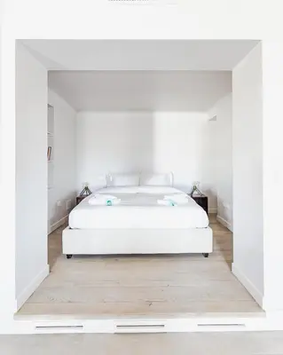 a white bedroom with a white bed in a room at Loft Piazza Vittorio - Zen 38 in Rome