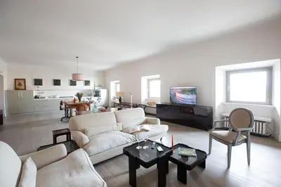 a living room with a white couch and a table at Loft Piazza Vittorio - Zen 38 in Rome