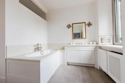a white bathroom with a sink and a mirror at Loft Piazza Vittorio - Zen 38 in Rome