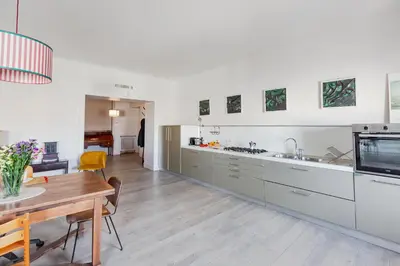 a kitchen with a table and a dining room at Loft Piazza Vittorio - Zen 38 in Rome