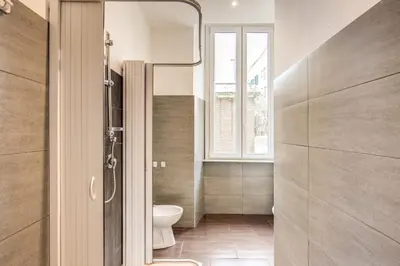 a bathroom with a toilet and a window at GuestHouse o Affittacamere La civetta di Trastevere in Rome