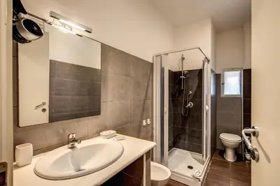a bathroom with a sink and a shower at GuestHouse o Affittacamere La civetta di Trastevere in Rome