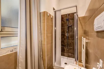 a bathroom with a shower with a glass door at GuestHouse o Affittacamere La civetta di Trastevere in Rome