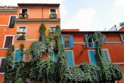 a building with a bunch of ivy growing on it at Trastevere Penthouse amazing terrace in Rome