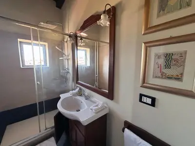a bathroom with a sink and a shower at Trastevere Penthouse amazing terrace in Rome