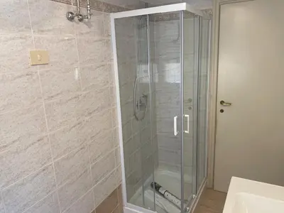 a shower with a glass door in a bathroom at Clodio Apartment in Rome