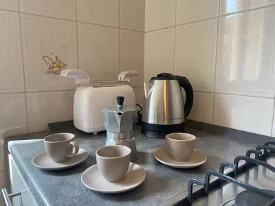 a kitchen counter with two cups and a coffee maker at Clodio Apartment in Rome