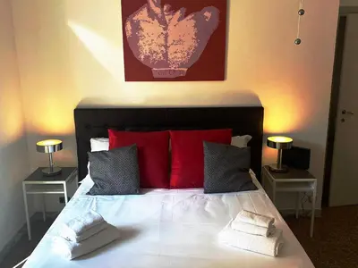 a bedroom with a large bed with red pillows at Clodio Apartment in Rome
